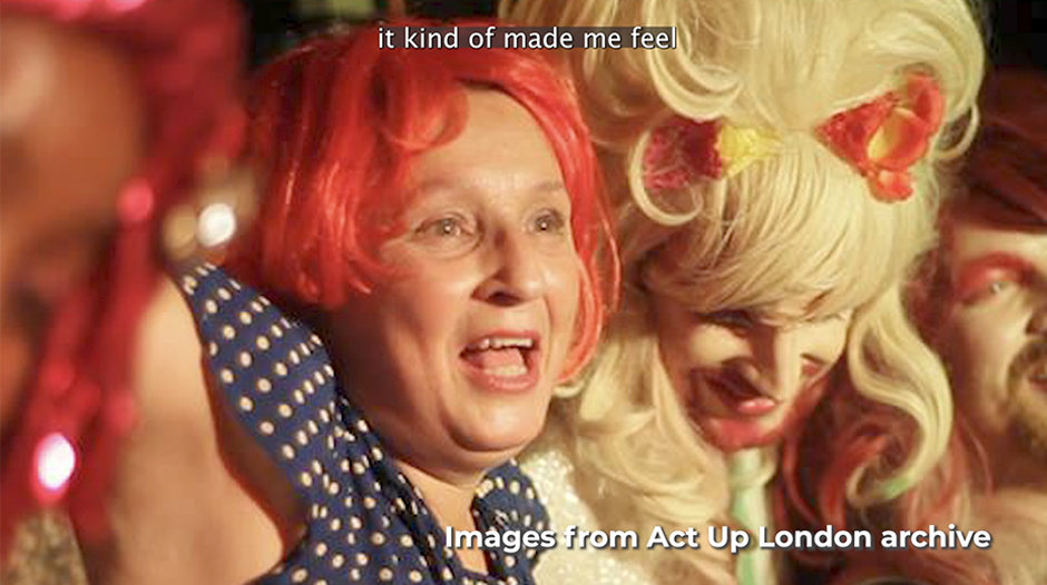 Video still of joyful Clare Groves wearing a red wig.